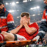 A dramatic football stadium scene at night An inj.jpg